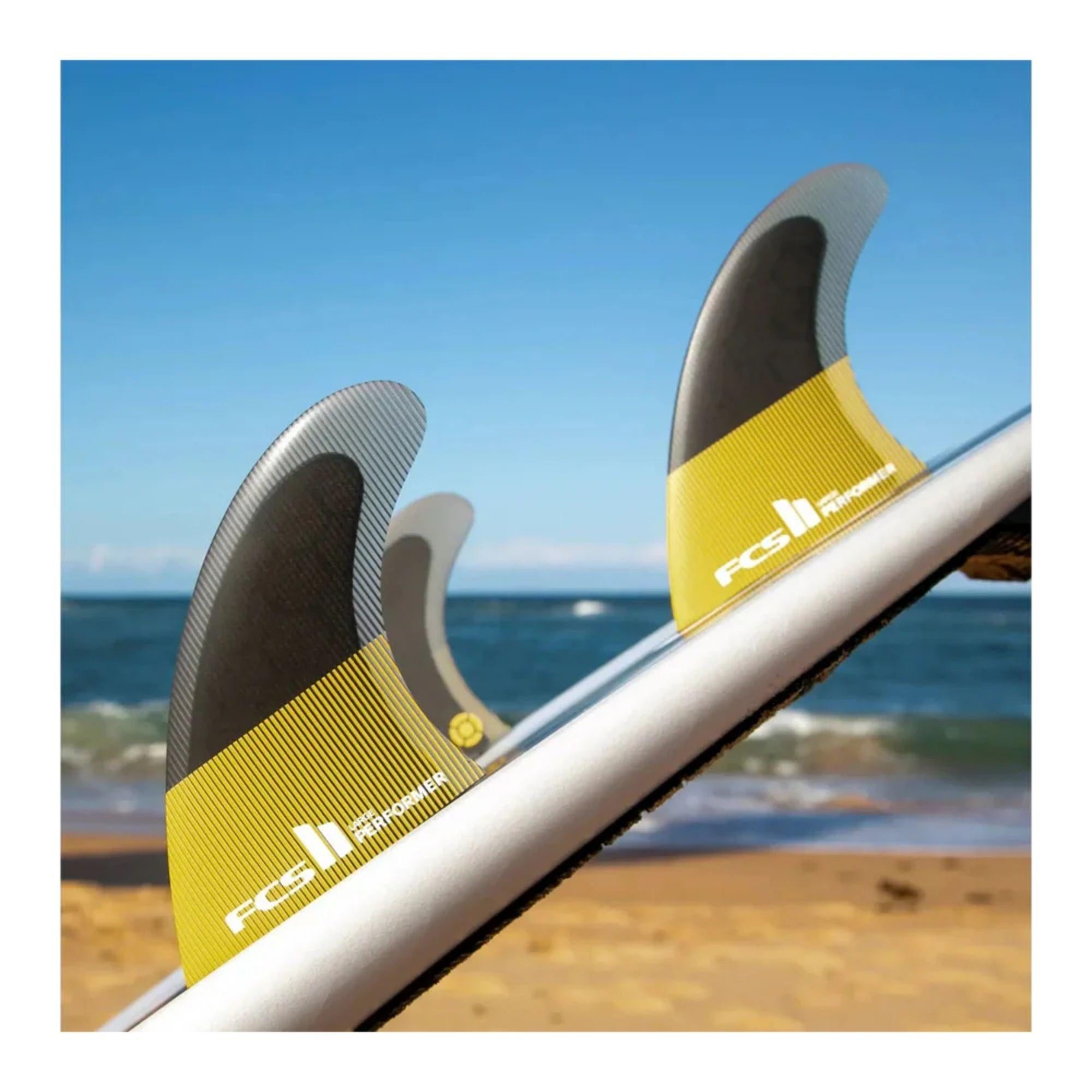 aileron de surf noir et jaune montes sur planche de surf arriere plan mer