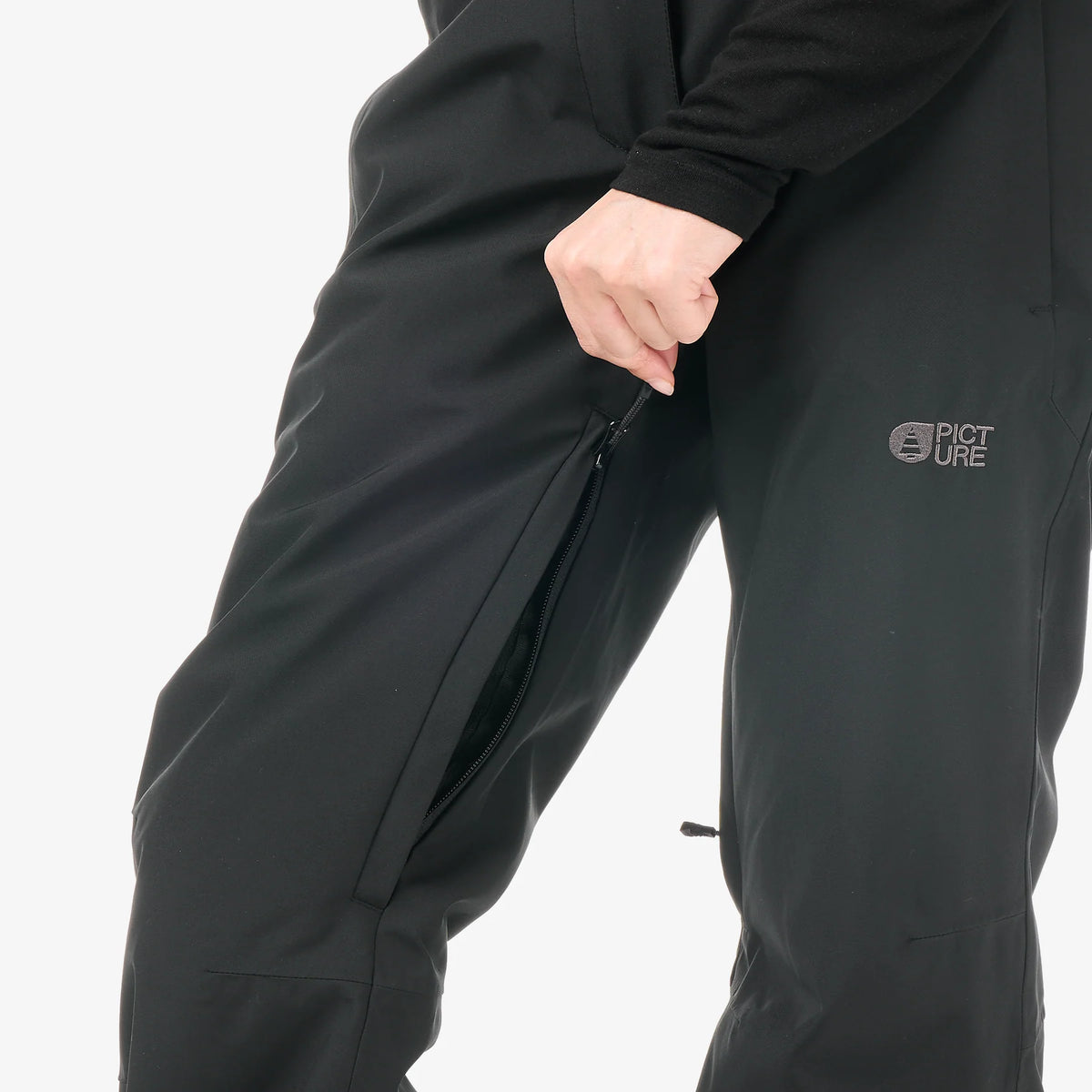 Gros plan sur la cuisse du pantalon de ski Picture Exa Black avec poche zippée et finition noire
