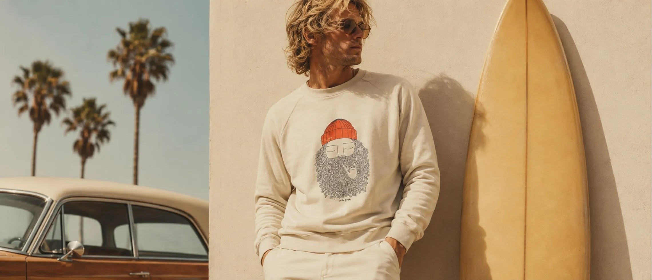 homme avec sweatshirt blanc sur plage de calisfornie 70's