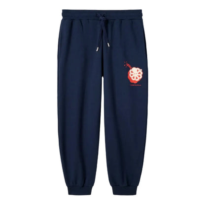 Vue produit du pantalon bleu marine, cordon de serrage contrasté et emblème dynamite poulpe corail sur le haut de la cuisse