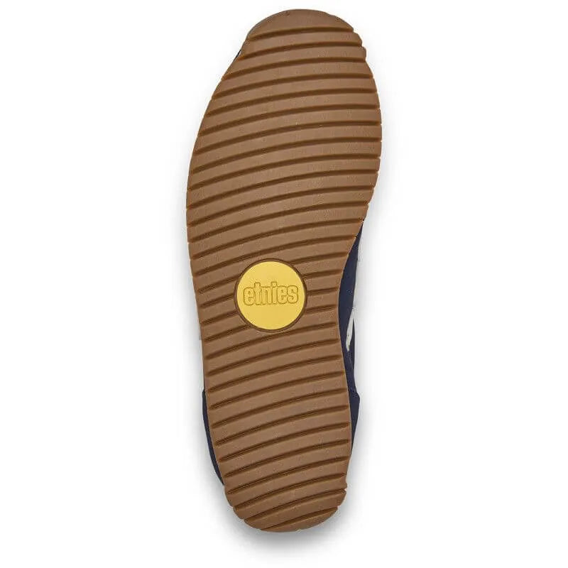 Semelle extérieure couleur gomme des Etnies Lo-Cut 2K Navy Yellow, rainures horizontales et pastille ronde jaune.