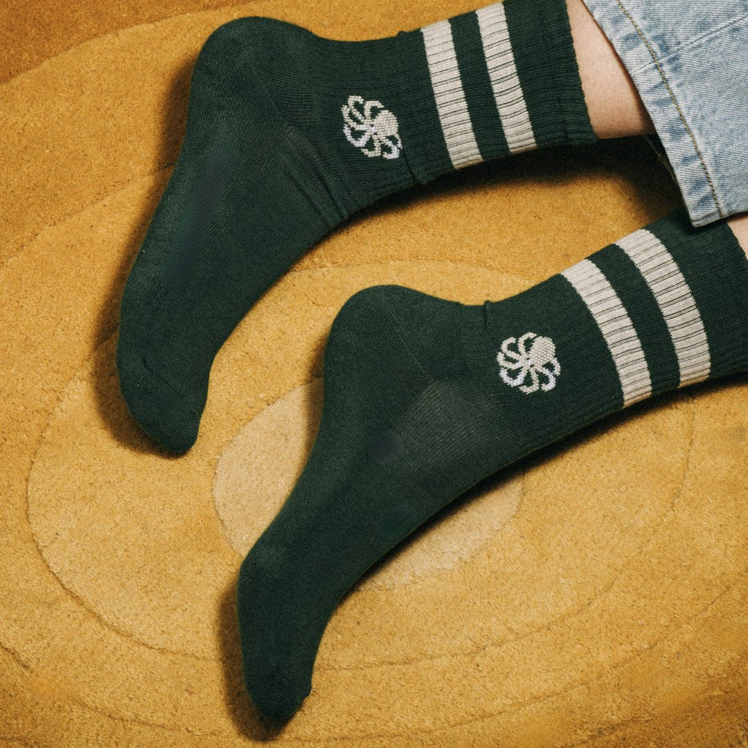 chaussettes sprint green coconut portées avec arriere plan tapis retro orange