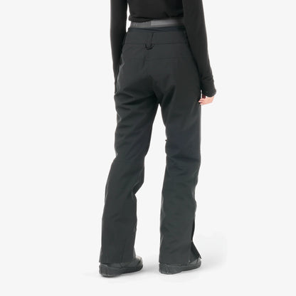 Vue arrière du pantalon Picture Exa Black porté, jambes droites et bas ajusté sur des boots de neige