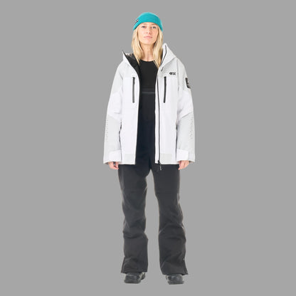 Veste de ski et snowboard femme Picture Orakoon JKT Brillant White portée en pied avec pantalon noir